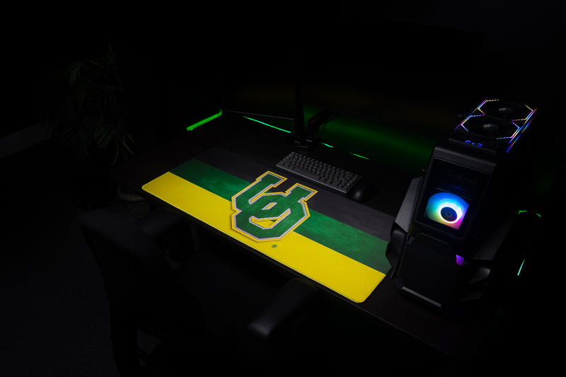 Wide view of the Oregon Pride deskmat across a gaming workstation.