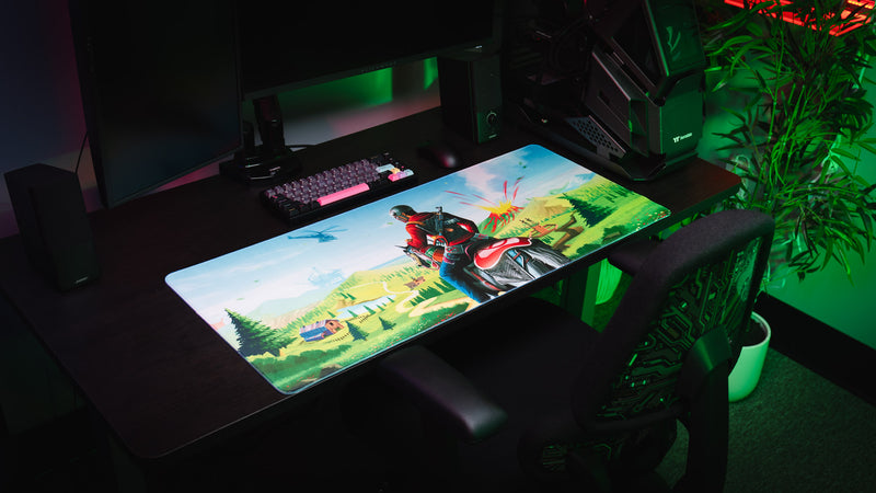 Willy and his Horse gaming deskmat on a desktop setup featuring a rider on horseback overlooking a scenic landscape with an offshore rig, helicopter, and erupting volcano.