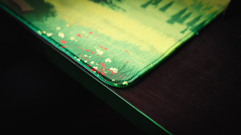 Close-up of the stitched edge on the Willy and his Horse gaming deskmat, highlighting the premium fabric surface and reinforced craftsmanship.