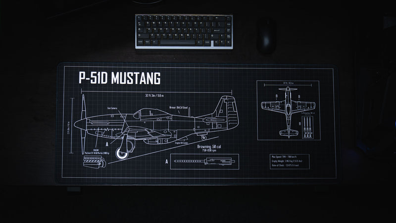 Top-down view of the Wings of Liberty P-51D Mustang blueprint deskmat featuring detailed aircraft schematics, technical callouts, and a black drafting grid design.