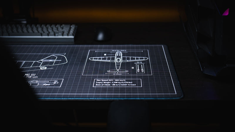 Close-up of the Wings of Steel deskmat highlighting the BF 109 G-6 tail section blueprint, top-view aircraft schematic, technical specifications, and premium stitched edge.
