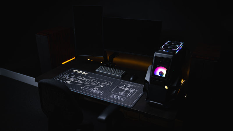 Modern RGB gaming setup featuring the Wings of Steel BF 109 G-6 blueprint deskmat with a mechanical keyboard, gaming mouse, desktop PC, and detailed aircraft engineering schematic.