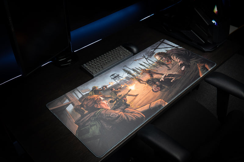 Angled view of the Xclusion Final Stand deskmat on a desk with keyboard and monitor